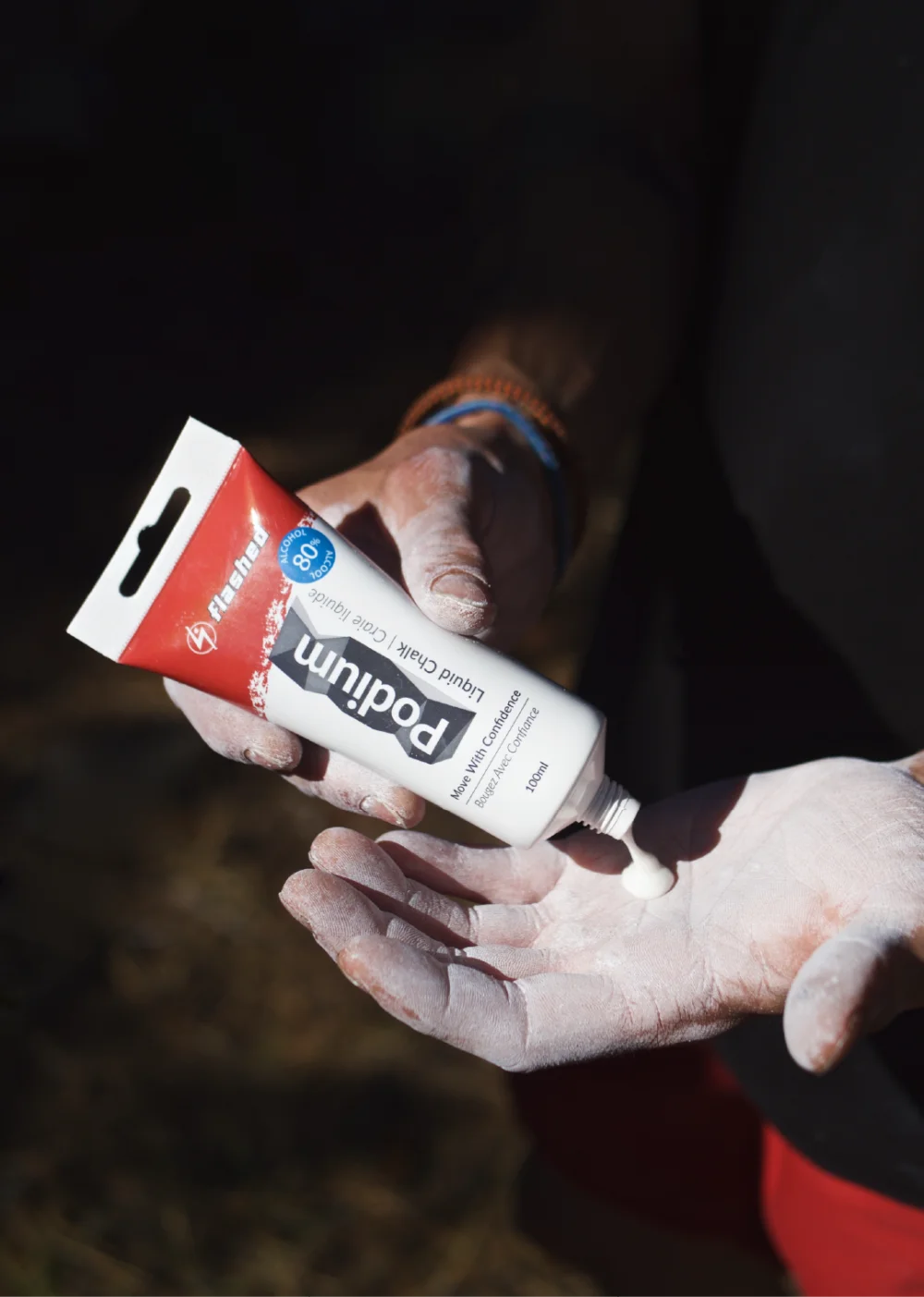 Liquid chalk being applied to hands for climbing