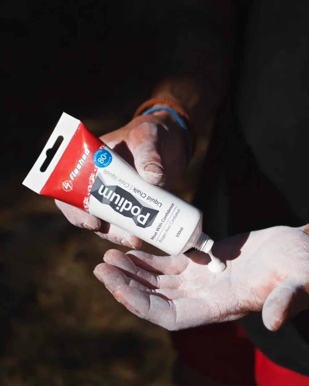 Liquid chalk being applied to hands for climbing